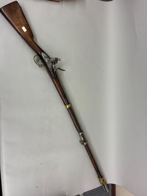 an old gun and a rifle are on display in a display case