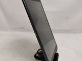 a close up of a tablet computer on a stand on a white surface