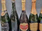six bottles of champagne are lined up in a row on a table