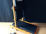 a wooden table with a black chair and some keys on it