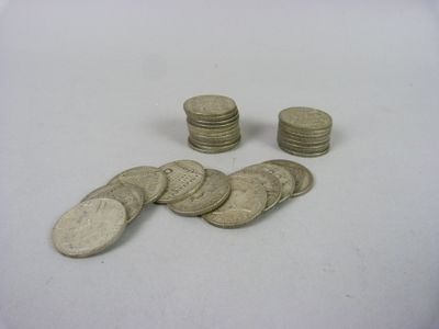 a pile of coins sitting on a table next to a pile of coins
