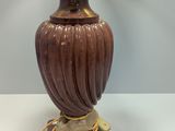 a lamp that is sitting on a table next to a lamp shade