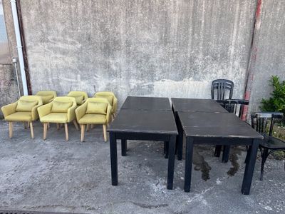 quatre chaises et une table devant un mur en béton