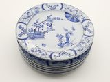 several plates with blue and white designs are stacked on top of each other
