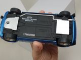a person holding a toy car in their hand