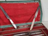a green case with knives inside of it on a table