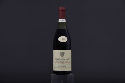 the bottle of wine is sitting on a black table