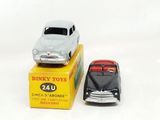 two toy cars that are sitting on top of a box