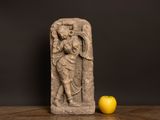 sculpture of an angel and an apple on a wooden table