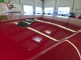 a remote control on the hood of a red car
