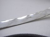 a knife that is laying on a table next to a bowl