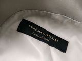 the label of a white jacket with a black and gold logo on it