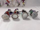 seven figurines of people riding on a horse drawn carriage