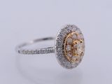 a close up of a diamond ring on a white surface