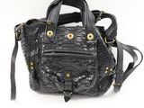 a black handbag with gold hardwares on a white background