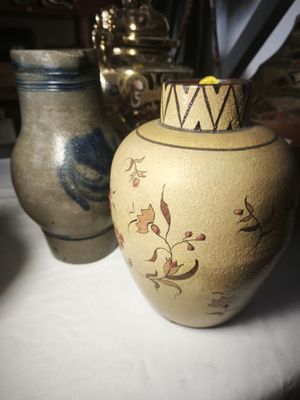 two vases that are sitting on a table