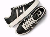 black and white converse sneakers with white laces on a white background