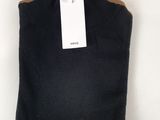 a close up of a black sweater with a tag on it