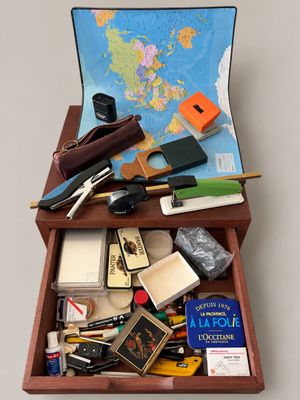 a suitcase with a map and other items in it
