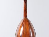 a close up of a mandolin hanging from a string