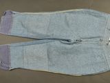 pair of blue jeans with yellow zippers laying on a table