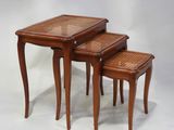 two tables with rattan tops and wooden legs on a white background