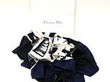 a black and white scarf and a blue and white scarf on a white table