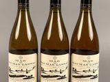 trois bouteilles de vin posées sur une table l'une à côté de l'autre