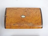 a small wooden box that is on a white surface
