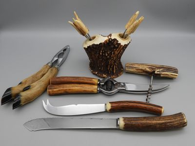 a knife, fork, knife holder, and other tools on a table