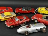 several toy cars are lined up in a row on a black surface