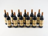 six bottles of wine lined up in a row on a white surface
