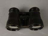 a close up of a pair of binoculars on a white surface