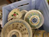 many different types of teapots and cups in a blue container
