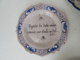 a plate with writing on it sitting on a table