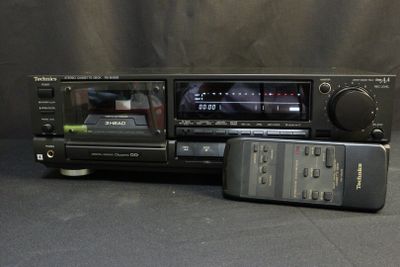 two remote controls and a radio on a table