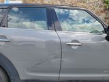 a car that is parked in front of a stone wall