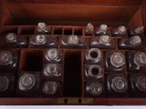many empty bottles in a wooden box on the table