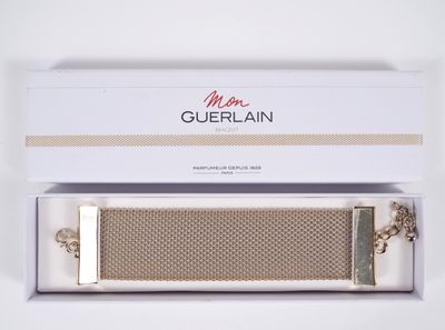 a close up of a watch in a box on a white surface