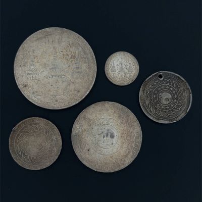 three bowls and two bowls with designs on them on a black surface