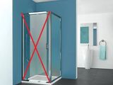 a picture of a bathroom with a blue wall and a glass shower