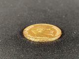 a gold coin sitting on top of a black cloth