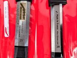 two blades that are sitting on a red surface