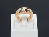 a close up of a gold ring with multi colored stones