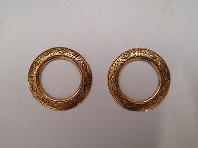 two gold tone earrings with a circular design on them