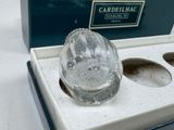 a glass object in a box on a table