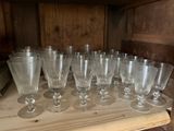 a lot of empty wine glasses sitting on a shelf