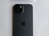 a black apple iphone sitting next to a white charger