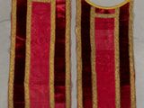 two red and gold striped vests on a white surface