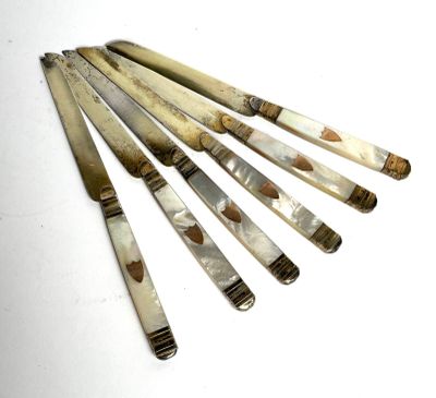 six pieces of silver and white marble pens on a white surface